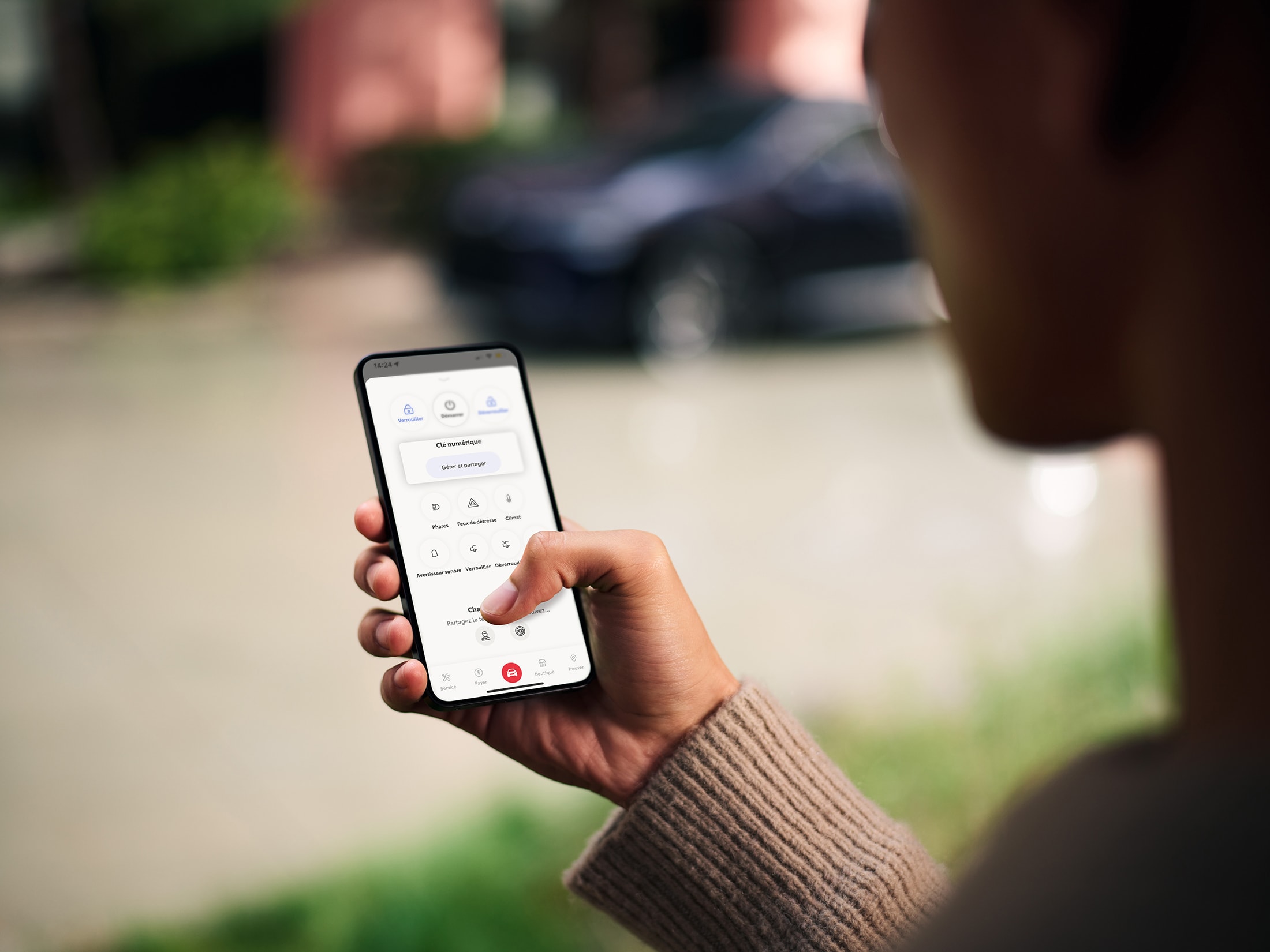 Person using the Toyota App Wallet on a smartphone to manage vehicle charging and remote features.