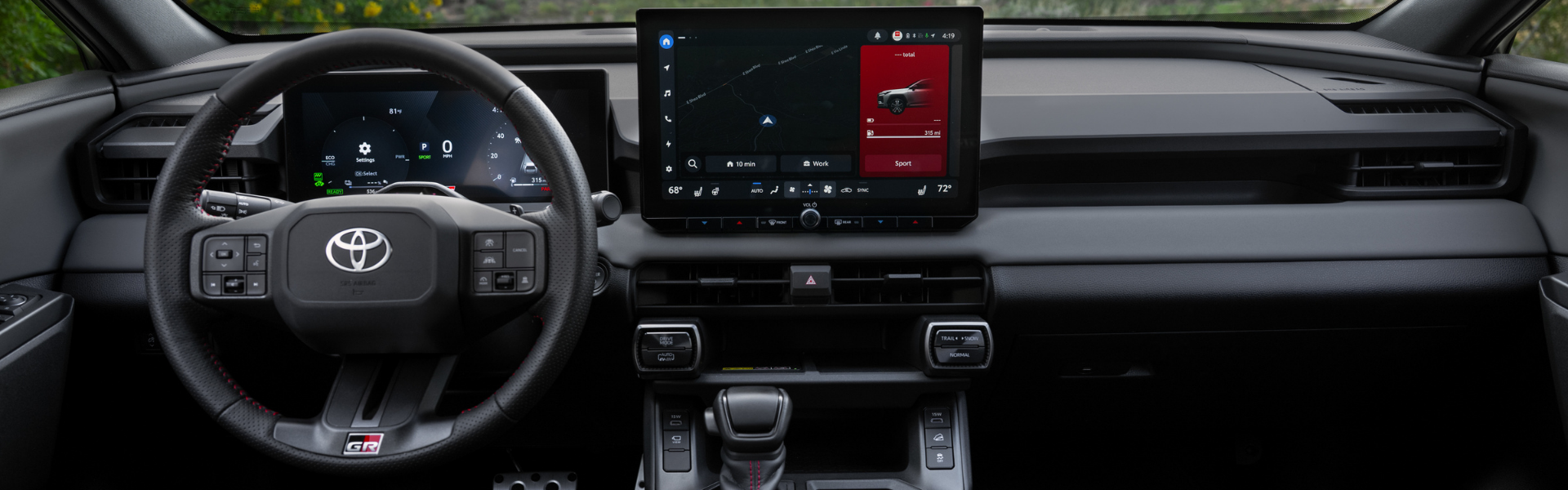 Interior dashboard of the 2026 Toyota RAV4 PHEV GR Sport with steering wheel, digital gauge cluster, and centre touchscreen