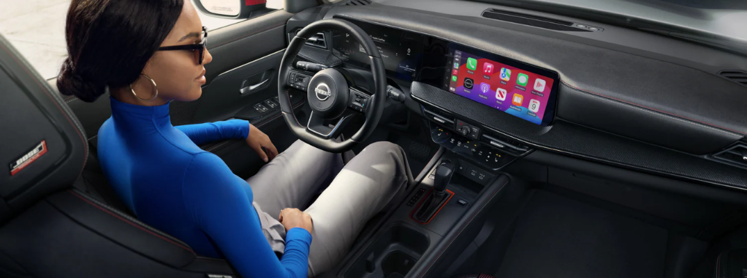 Woman sitting in the driver seat of the 2026 Nissan Kicks