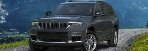 2023 Jeep Grand Cherokee driving down a dirt road