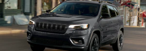 2023 Jeep Cherokee driving down a city street