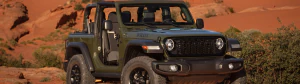 2024 Jeep Wrangler driving down a desert road