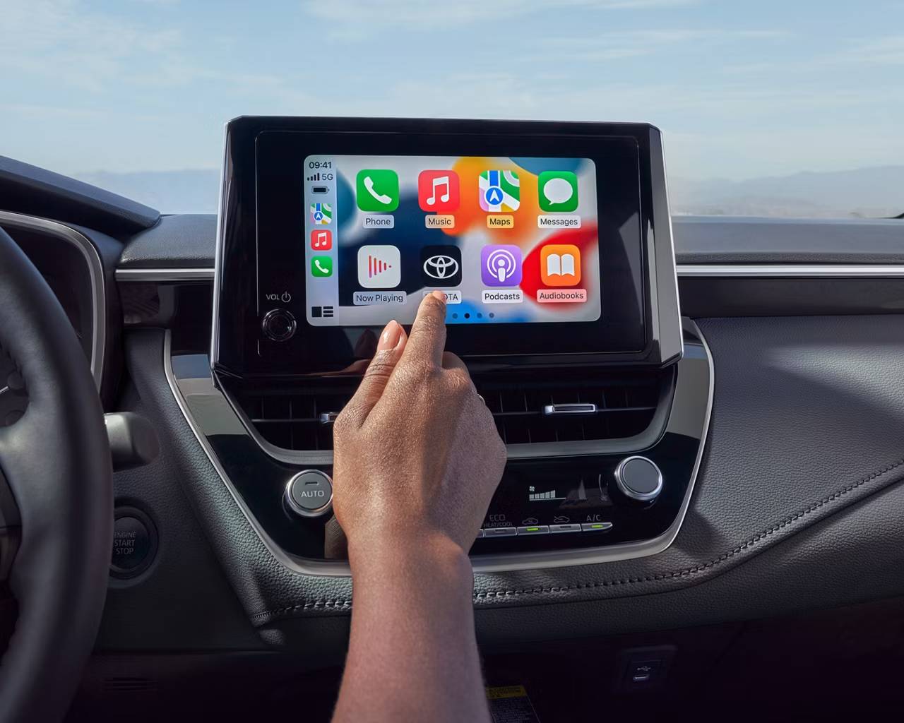 Person using infotainment screen.