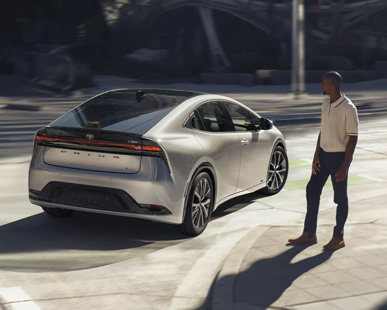 Toyota Prius HEV turning a corner, unknown person watching