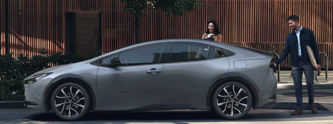 Unknown people walking to enter prius phev
