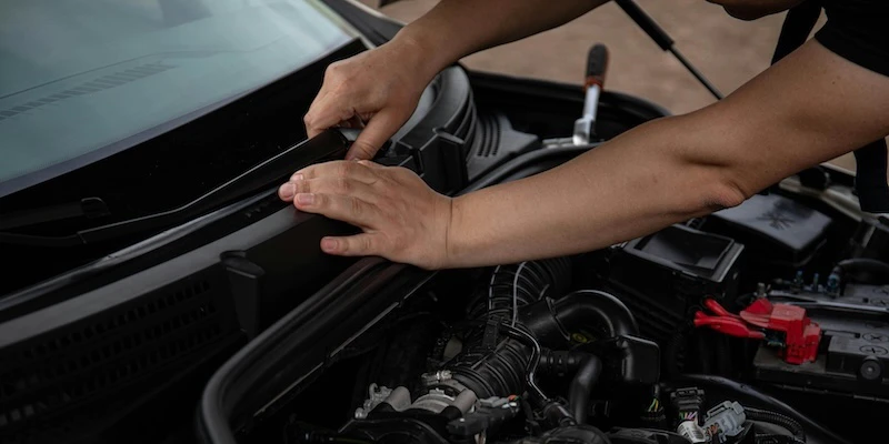 A used vehicle owner puts on new windshield wipers.