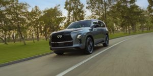 QX80 driving on road during the day.