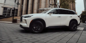 2025 INFINITI QX60 driving on brick road