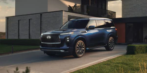 2025 INFINITI QX80 parked on residential driveway.