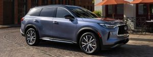 2025 infiniti qx60 parked on brick road during daytime.