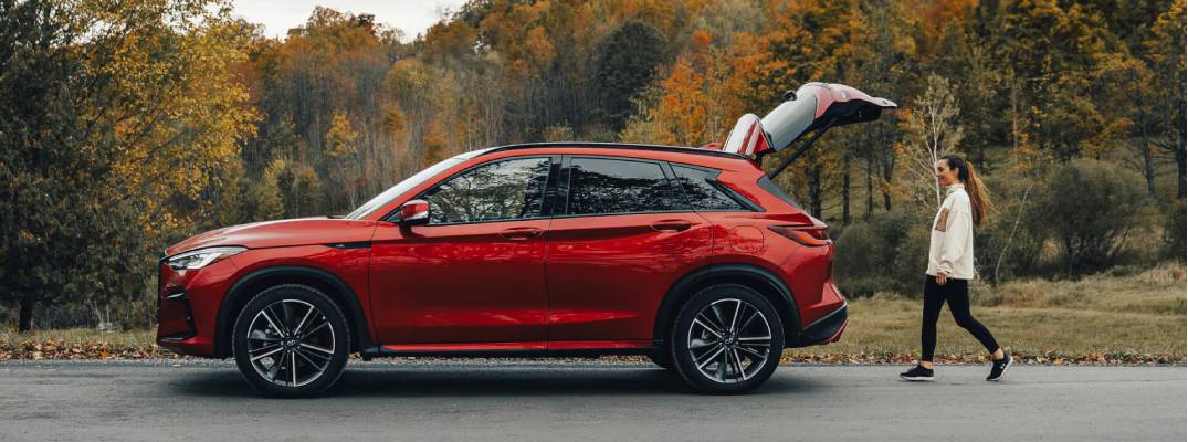Woman walking towards 2025 QX50 with truck open. 