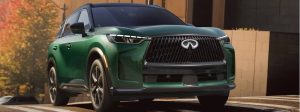 QX60 driving down street.
