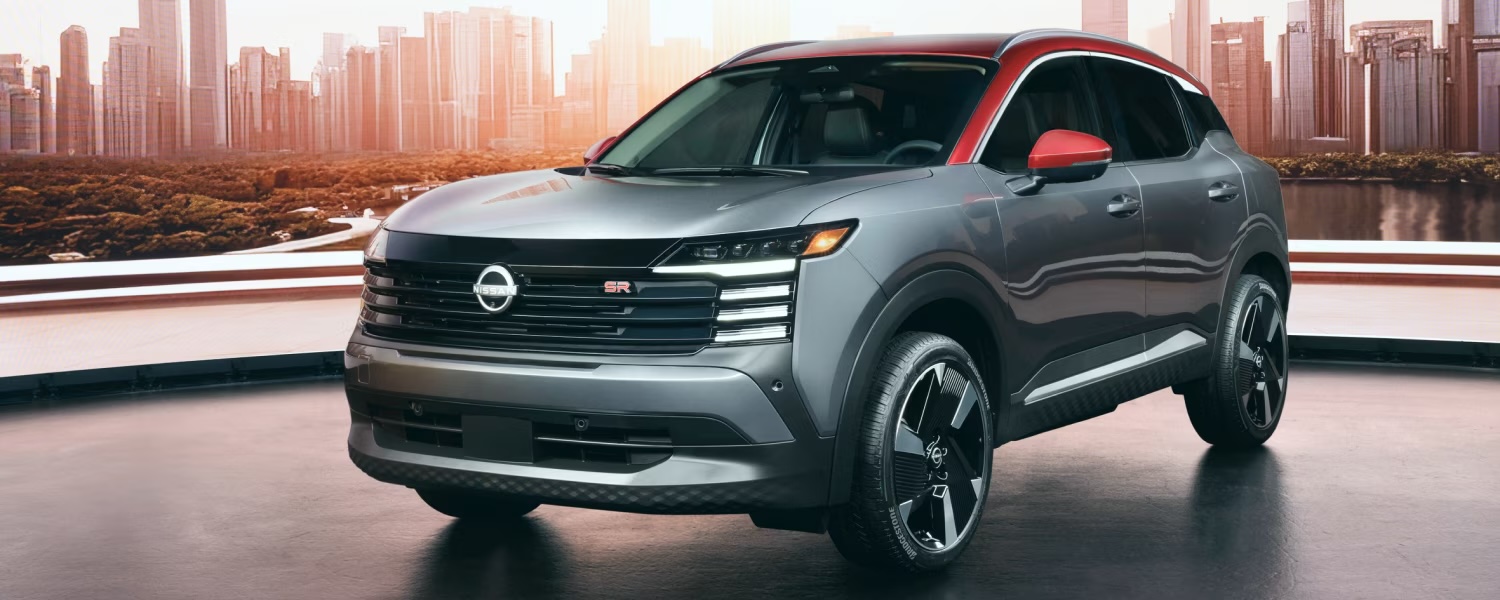 2025 Nissan Kicks with city scape in background. 
