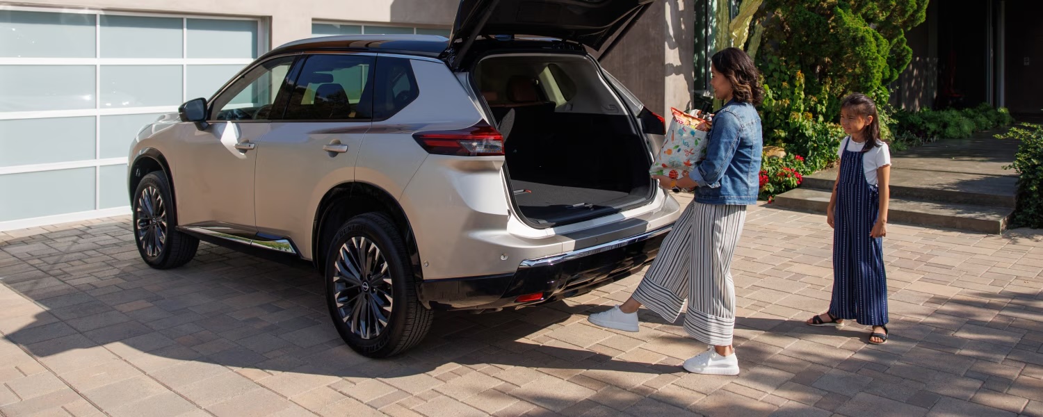 Woman opening 2025 Nissan Rogue trunk 