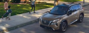2025 Nissan Rogue parked on busy street.
