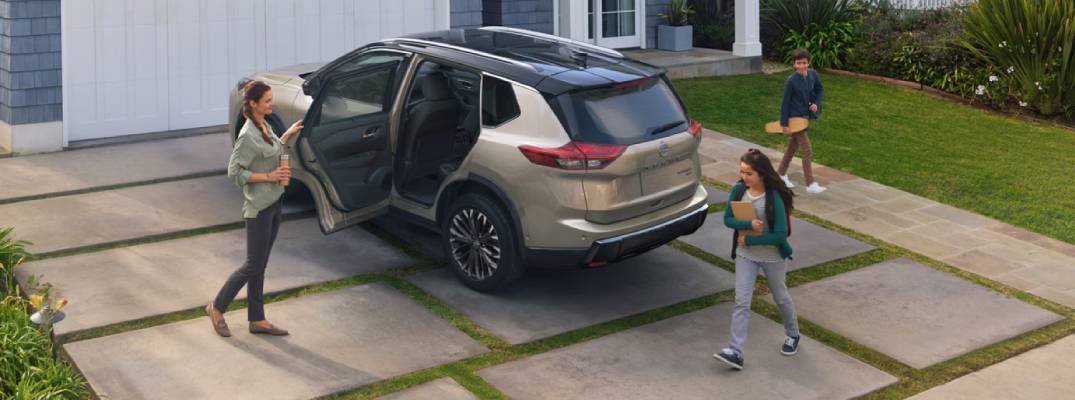 Family standing around 2026 Nissan Rogue