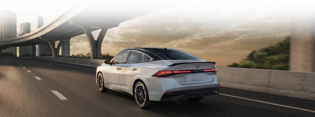 2026 Nissan Sentra driving down road.