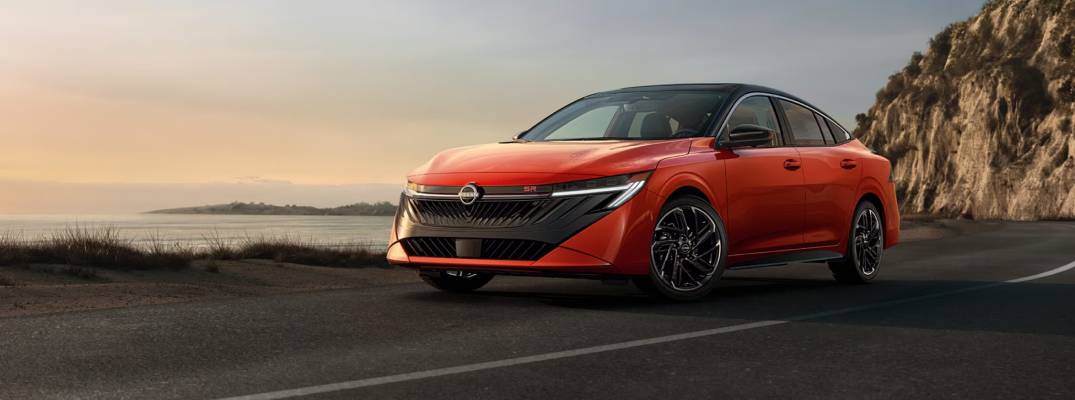 2026 Nissan Sentra driving down road.