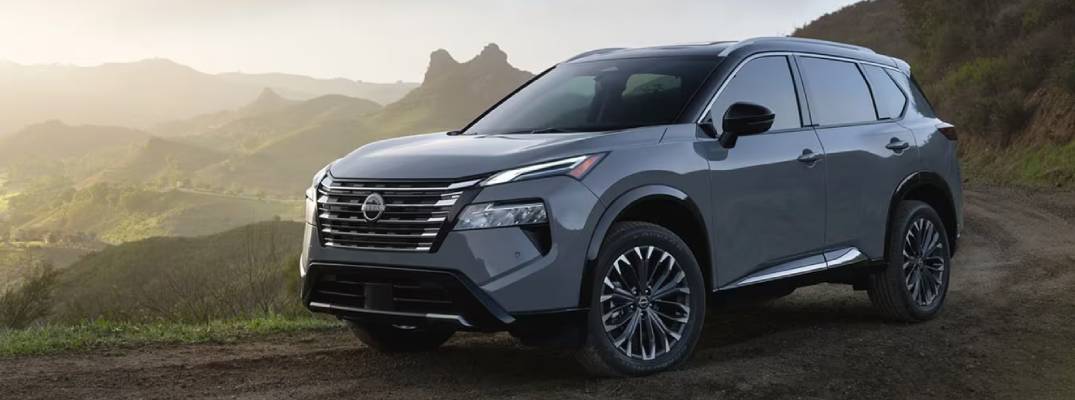 2026 Nissan Rogue driving down road. 