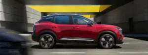 2026 Nissan Kicks driving down busy street