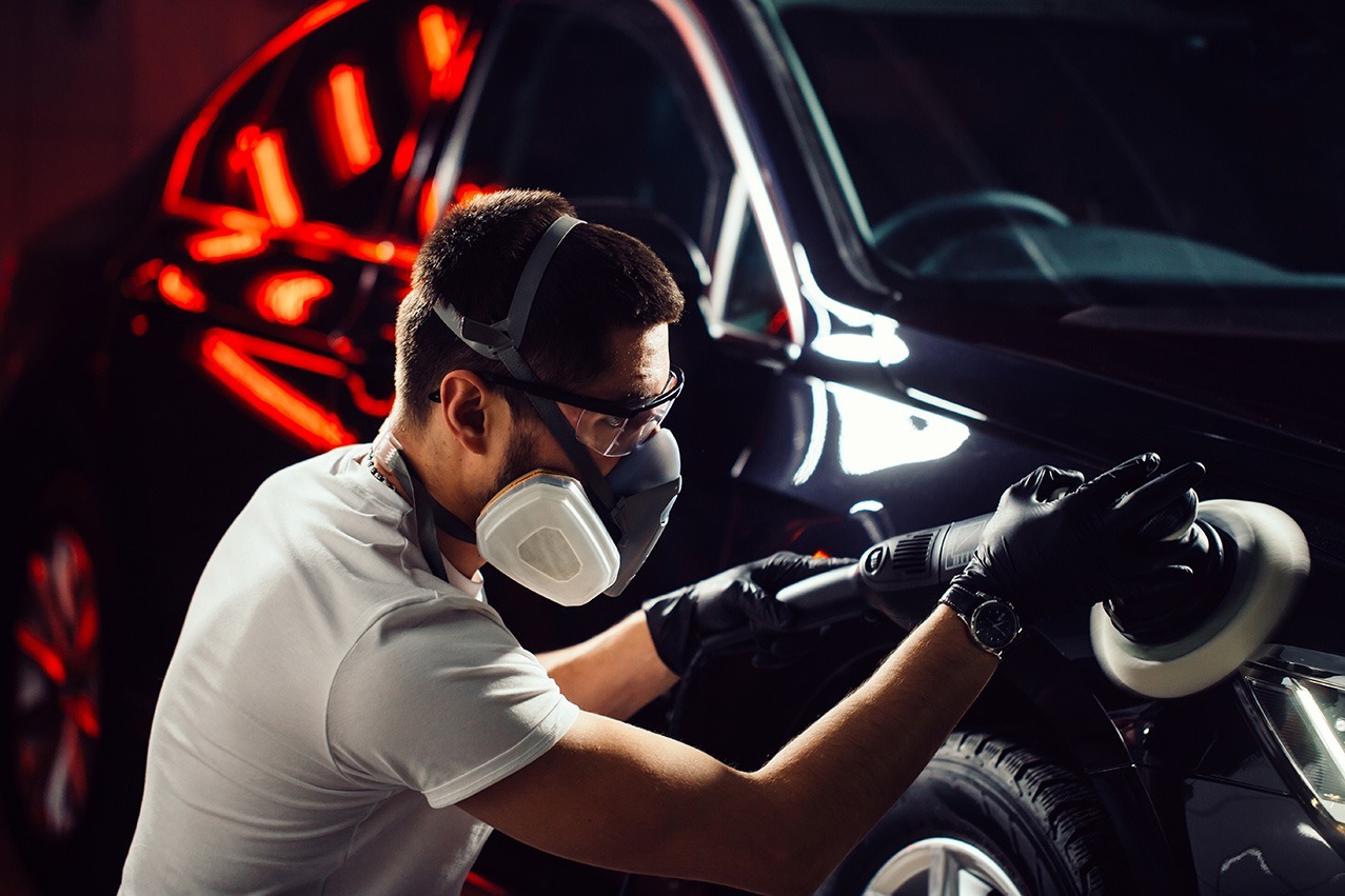 imgi_3_imgi_3_Car-polish-wax.-worker-hands-holding-a-polisher.jpg
