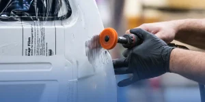 Technician completing auto body repair in Calgary