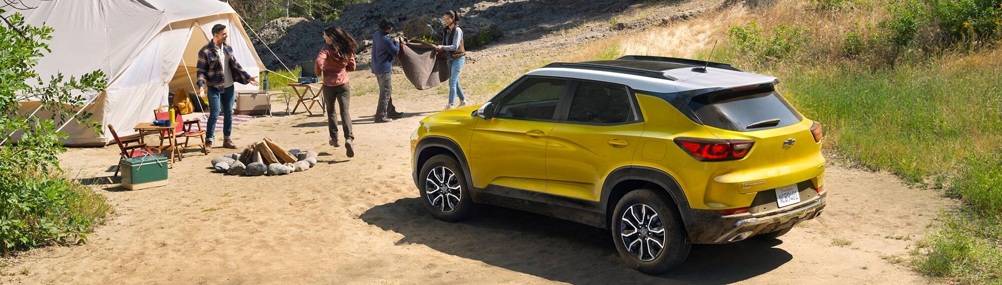 People camping in daylight with 2025 Chevrolet TrailBlazer parked nearby.