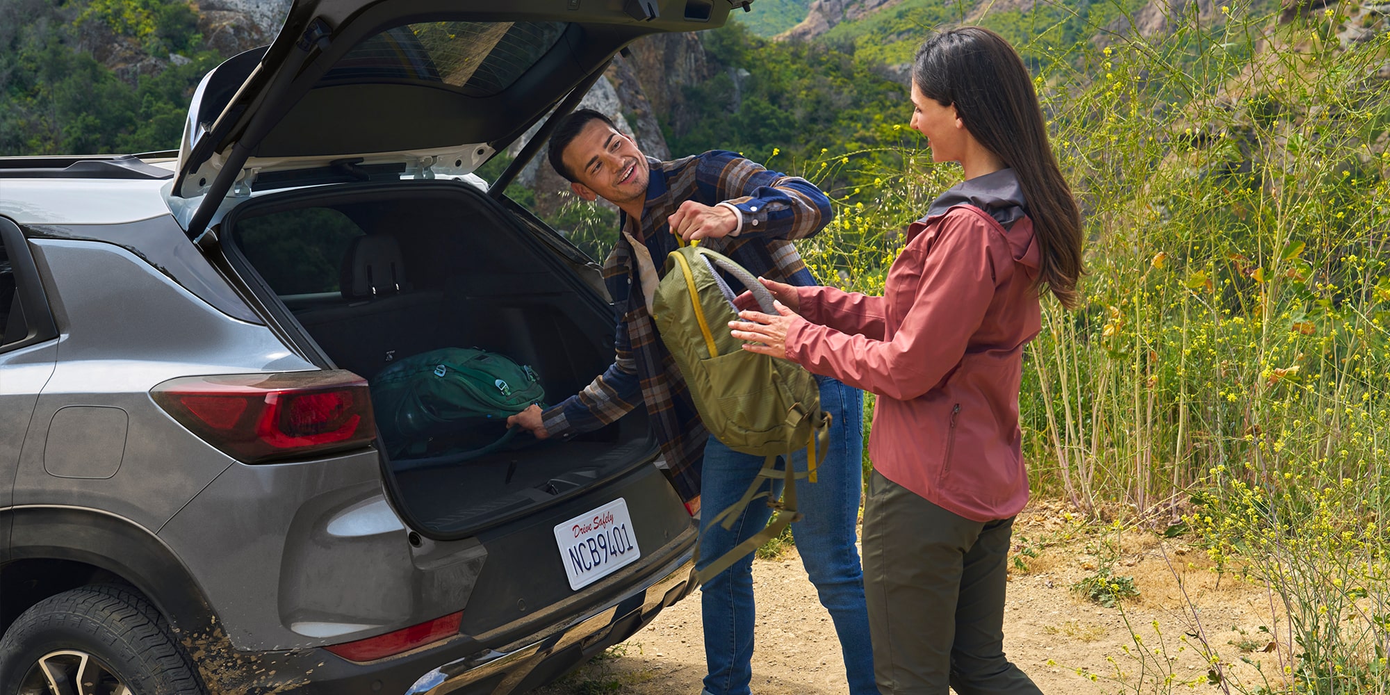 People removing cargo from rear of 2025 Chevrolet TrailBlazer.