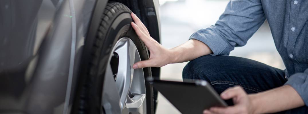 Unknown person inspecting tires