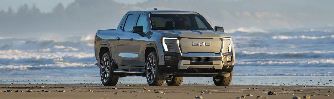 2025 GMC Sierra EV Denali parked on rocky terrain.