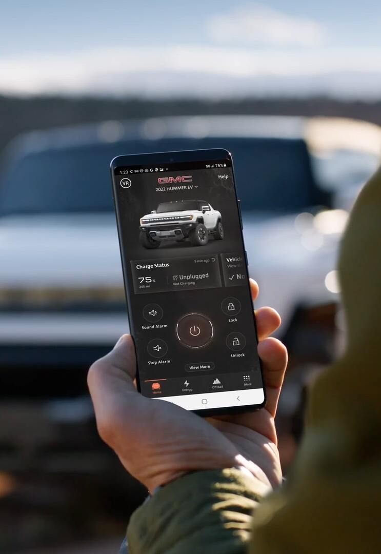 Person holding phone with GMC app.