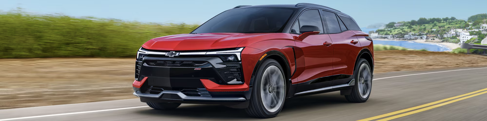 2026 Chevrolet Blazer EV driving down road during daytime