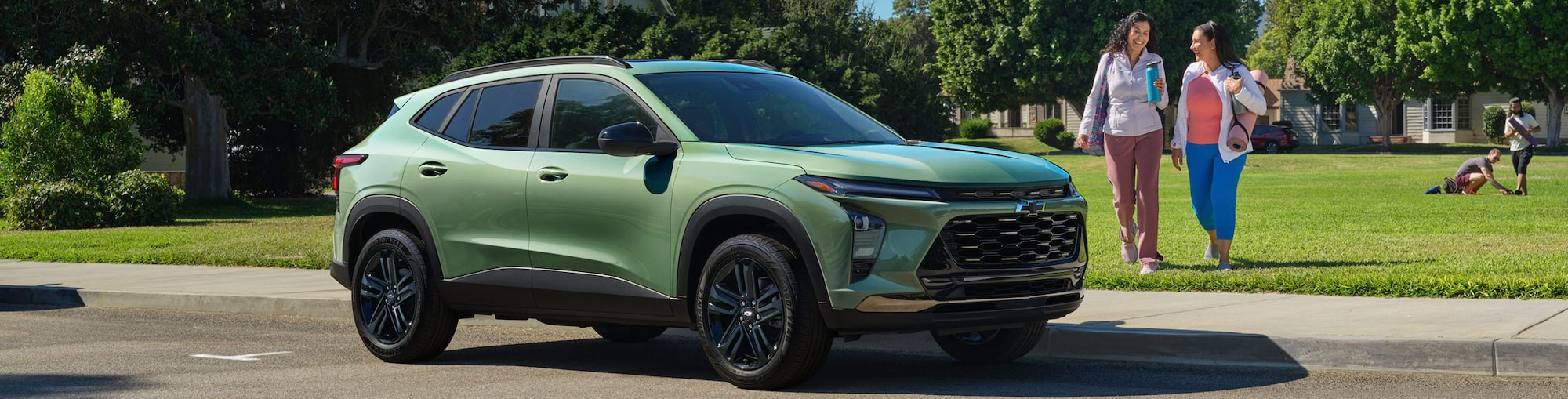 2026 Chevrolet Trax parked at the side of a road with people walking near it