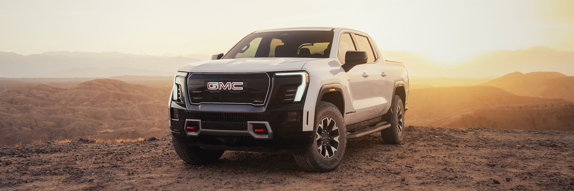 2026 GMC Sierra EV parked on rocky terrain