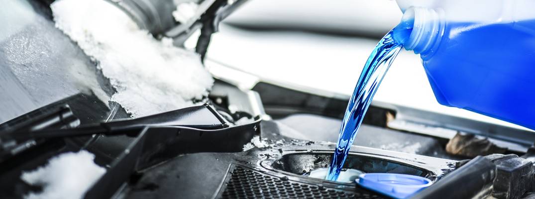 Unknown person putting fluid in vehicle.